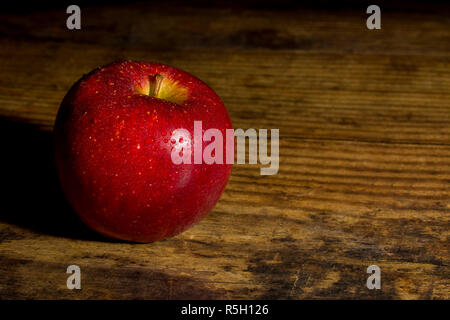 Close up of braeburn apples on a dark wooden board Stock Photo