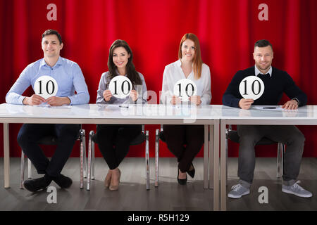 Panel Judges Holding 10 Score Signs Stock Photo