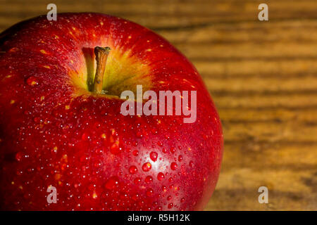 Close up of braeburn apples on a dark wooden board Stock Photo