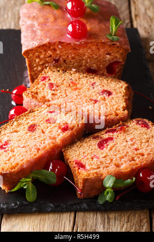 Delicious freshly baked sweet bread with maraschino cherries and mint close-up on the table. vertical Stock Photo