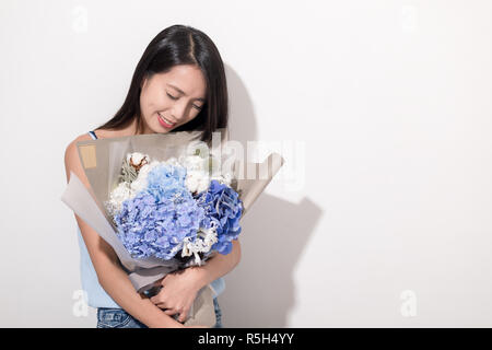 Young Woman holding a hydrangea bouquet flower Stock Photo