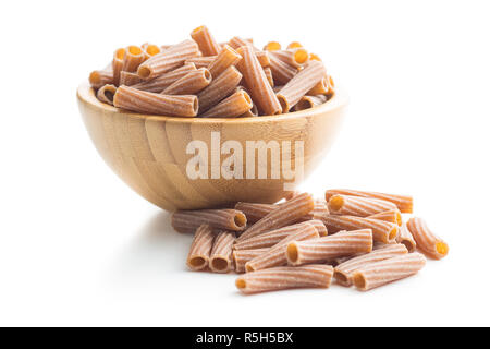 Dried rigatoni pasta in wooden bowl. Stock Photo