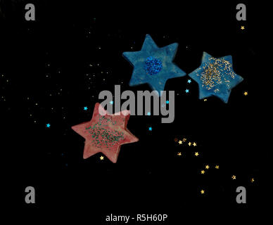 Blue and red ceramic and plastic stars with black background Stock Photo
