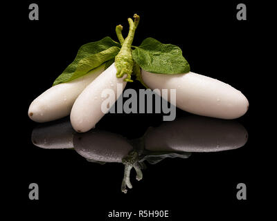 Three white eggplants isolated on black Stock Photo