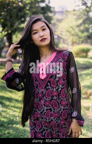 Girl in Chikankari Kurti by Zahba posing for the camera in a park. Stock Photo