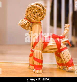 FLODA, SWEDEN - NOVEMBER 28 2018: Close up view of typical Swedish handmade straw Christmas ornament Yule goat decorated with red ribbon Stock Photo