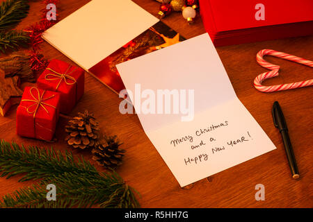 Handwritten Christmas Card, just signed with a marker. Stack of other cards and envelopes in the background. Photo on front of the card is mine. Stock Photo