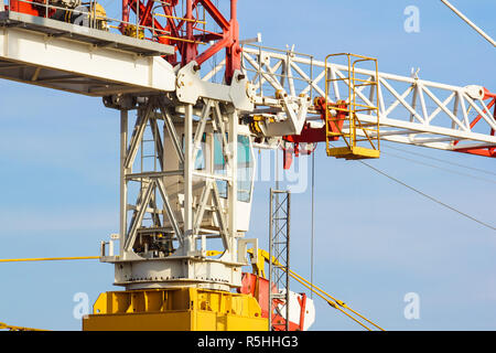 part of yellow construction tower crane arm against blue sky Stock Photo