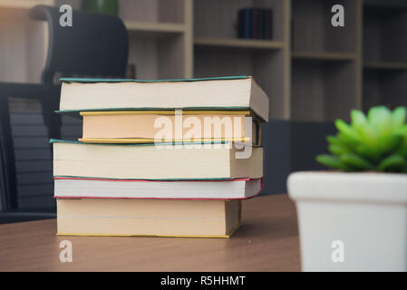 Pack of Book stack on table in working room at office Stock Photo