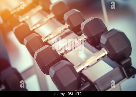 dumbbells in the gym at sports club for exercise and Bodybuilding Stock Photo