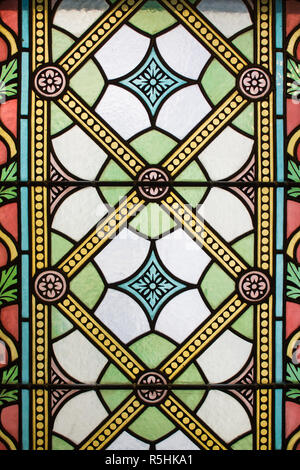 Front view of the stained glasses. Colorful ancient windows from the interior with light. Seamless background pattern or texture. Stock Photo