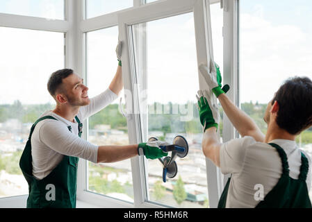 Workers installing a window Stock Photo