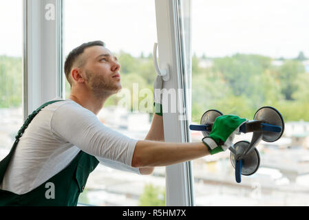 Handyman is repairing a window Stock Photo