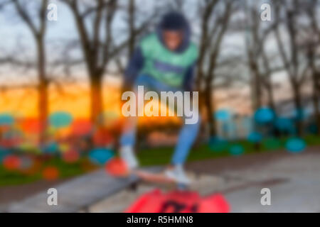 young skateboarder jumping on a ramp outdoor Stock Photo