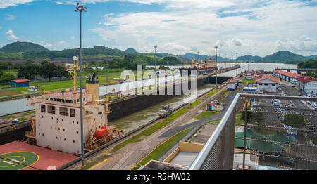 Large cargo ships pass through the Panama Canal locks.  This everyday event, provides income from both fees, and tourism, for the whole country. Stock Photo