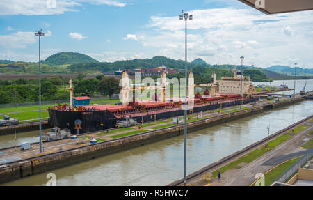 Large cargo ships pass through the Panama Canal locks.  This everyday event, provides income from both fees, and tourism, for the whole country. Stock Photo