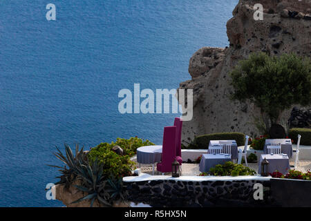 Restaurant with terrace on the cliffside in Oia, Santorini, Greece. Infinite sea in background, Stock Photo