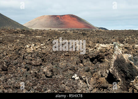 Volcanos and lava fields forming a dramatic landscape with little growing here in the Timanfaya National Park, Lanzarote, Canary islands. Stock Photo