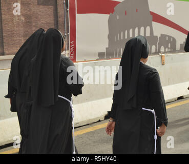 Rome, Italy-October 07, 2018, three nuns dressed in black robes walking the streets of Rome, the view from the back Stock Photo