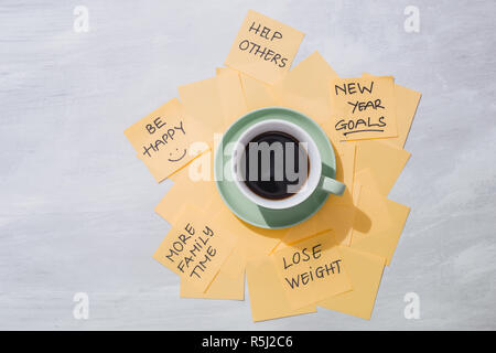 new year goals or resolutions - yellow sticky notes with coffee on table Stock Photo