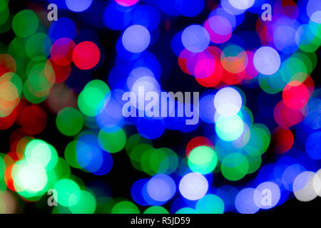 Christmas and festive multicoloured lights, blurred to give an abstract effect and colourful Christmas background. Stock Photo
