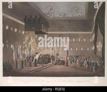 The coffin of Viscount Nelson inside the Painted Chamber at Greenwich Hospital on the left-hand side; figures dressed in black nearby; flags throughout the scene; a crowd of people mourning behind a low wall to the right. Remains of Lord Viscount Nelson laying in state in the Painted Chamber at Greenwich Hospital. [London] : Published as the Act directs April 1 1806 by James Cundee, Albion Press, Ivy Lane, Paternoster Row., [April 1 1806]. Aquatint and etching with hand-colouring. Source: Maps K.Top.17.1-3.p.2. Language: English. Author: Merigot. Stock Photo