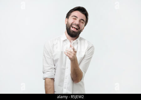 Portrait of a young man pointing his finger at you Stock Photo