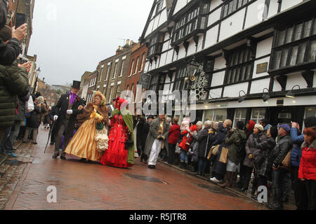 Rochester, Kent, UK. 1st December 2018: People dressed in Victorian costume from the Dickensian Age particiapte in the main parade on Rochester High Street. Hundreds of people attended the Dickensian Festival in Rochester on 1 December 2018. The festival's main parade has participants in Victorian period costume from the Dickensian age. The town and area was the setting of many of Charles Dickens novels and is the setting to two annual festivals in his honor. Photos: David Mbiyu/ Alamy Live News Stock Photo