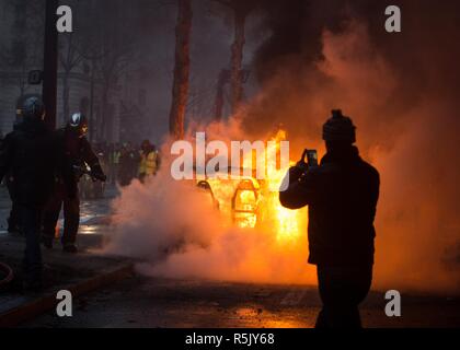 Paris, France. 1st Dec, 2018. A car seen burning near the Arc De Triomphe during a 'Yellow Vest' protest in Paris. Without any political affiliation, the ''˜Yellow Vest' movement rallies in various cities in France against taxes and rising fuel prices. Credit: Sathiri Kelpa/SOPA Images/ZUMA Wire/Alamy Live News Stock Photo