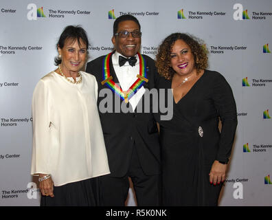 December 1, 2018 - Washington, District of Columbia, U.S. - Herbie Hancock, a 2013 Kennedy Center honoree and his wife, GiGi, left, and daughter Jessica, right, arrive for the formal Artist's Dinner honoring the recipients of the 41st Annual Kennedy Center Honors hosted by United States Deputy Secretary of State John J. Sullivan at the US Department of State in Washington, DC on Saturday, December 1, 2018. The 2018 honorees are: singer and actress Cher; composer and pianist Philip Glass; Country music entertainer Reba McEntire; and jazz saxophonist and composer Wayne Shorter. This year, the Stock Photo