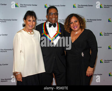 Herbie Hancock, a 2013 Kennedy Center honoree and his wife, GiGi, left, and daughter Jessica, right, arrive for the formal Artist's Dinner honoring the recipients of the 41st Annual Kennedy Center Honors hosted by United States Deputy Secretary of State John J. Sullivan at the US Department of State in Washington, DC on Saturday, December 1, 2018. The 2018 honorees are: singer and actress Cher; composer and pianist Philip Glass; Country music entertainer Reba McEntire; and jazz saxophonist and composer Wayne Shorter. This year, the co-creators of Hamilton, writer and actor Lin-Manuel Miranda Stock Photo