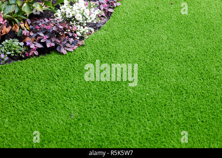 maintenance free artificial turf  lawn a modern synthetic grass carpet Stock Photo