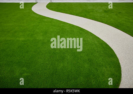 maintenance free artificial turf  lawn a modern synthetic grass carpet with resin path Stock Photo