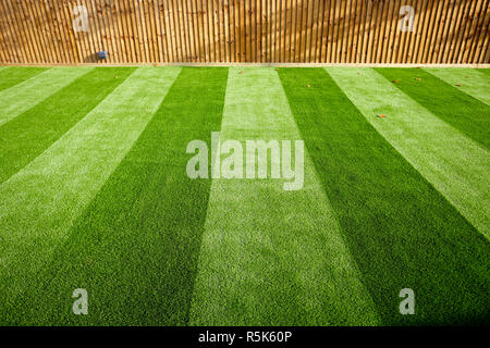 maintenance free artificial turf  lawn a modern synthetic grass carpet with stripes Stock Photo