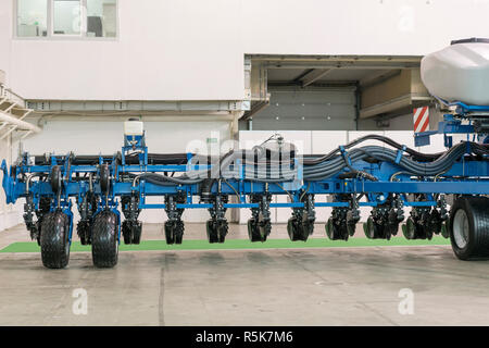 Corn harvester head with several silver blades. Agricultural machinery for soil cultivation Stock Photo