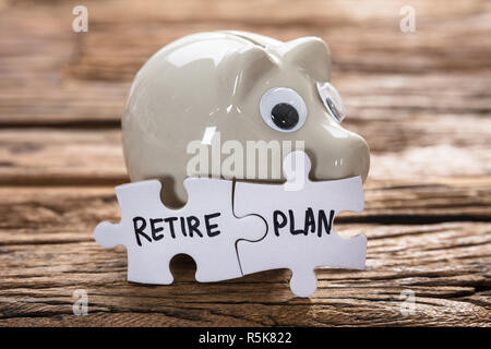 Connected Retire Plan Jigsaw Pieces By Piggybank Stock Photo