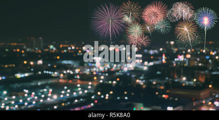 Colorful fireworks on blur city skyline background at night Stock Photo