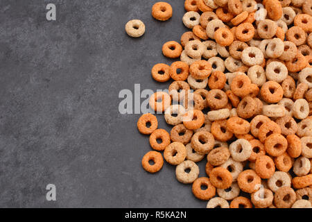 Multigrain hoops breakfast cereal on grey slate background Stock Photo