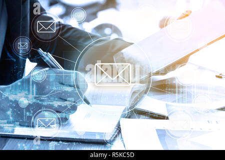 double exposure businessman writes business plan and email networking Stock Photo
