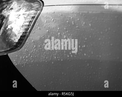 CLOSE-UP OF RAINDROPS ON CAR BODY Stock Photo