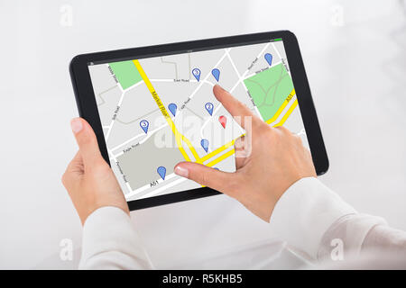 Person Using GPS Service On Digital Tablet Stock Photo