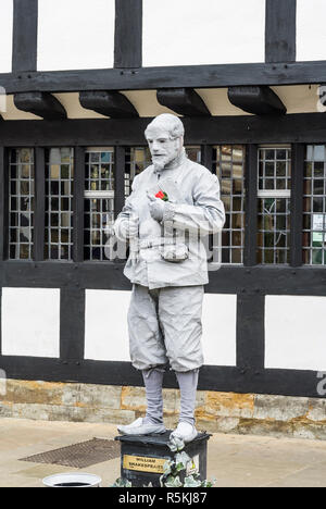 Street artist or Busker in Stratford upon Avon, England. Dressed to resemble a stone statue of William Shakespeare Stock Photo
