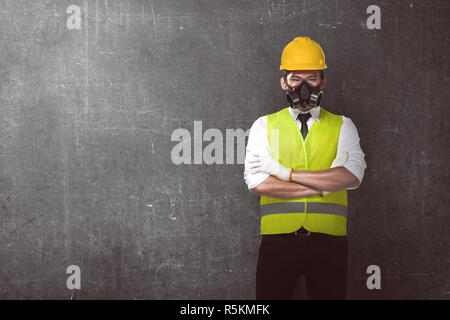 Asian worker wearing safety vest and yellow helmet Stock Photo