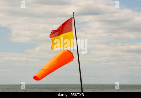 Lifeguard flag with windsock on beach at Brighton, East Sussex, England