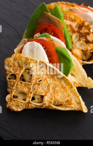 pancakes sutffed with ham,cheese,tomatoes and spinach Stock Photo