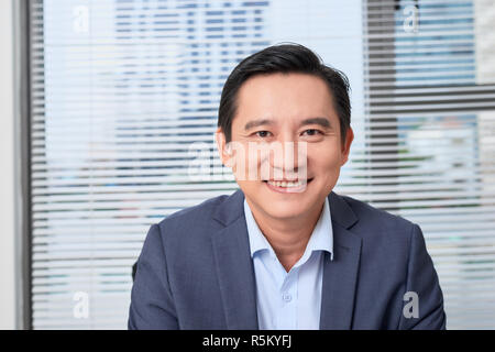 Asian businessman, an engineer with the work plan, sitting in the office. Stock Photo
