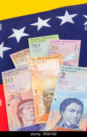 Venezuela flag with worthless Bolivar fuerte ('strong') banknotes - for Hyperinflation in Venezuela economy. SEE ADDIT. NOTES Stock Photo