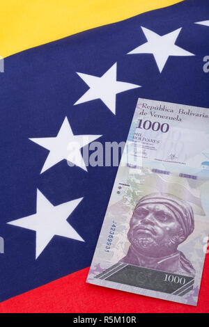 Venezuela flag with worthless Bolivar fuerte ('strong') banknote - for Hyperinflation in Venezuela economy. SEE ADDIT. NOTES Stock Photo