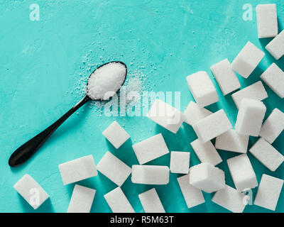 Top view of white sugar cubes on turquoise background Stock Photo