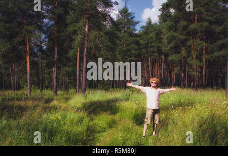 Man Raised Arms in Summer Forest Stock Photo